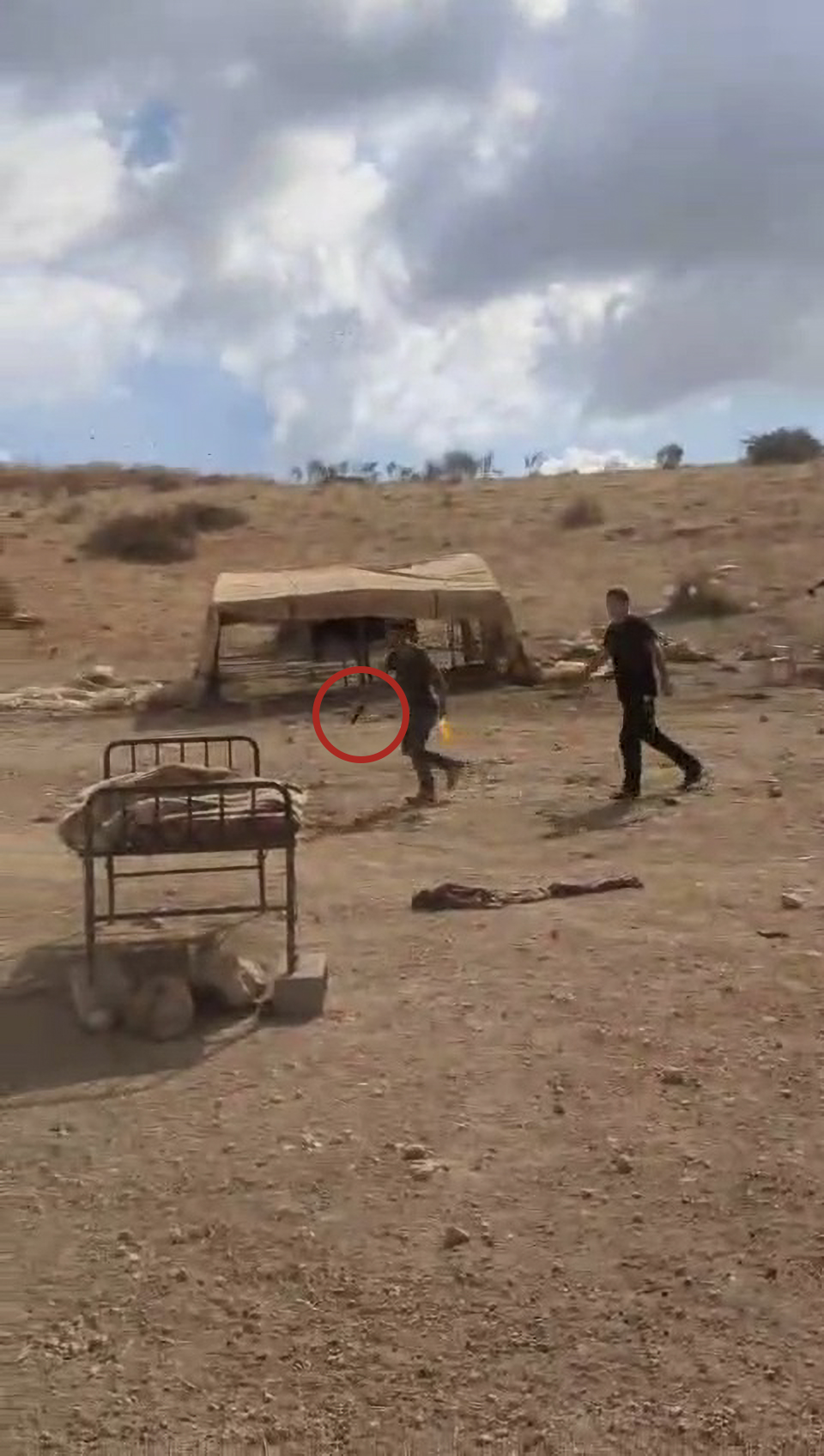 Settler drawing a handgun at Palestinians in Wad al-Fau